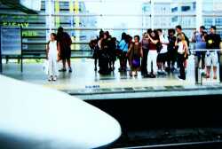 tourists taking photos of Shinkansen